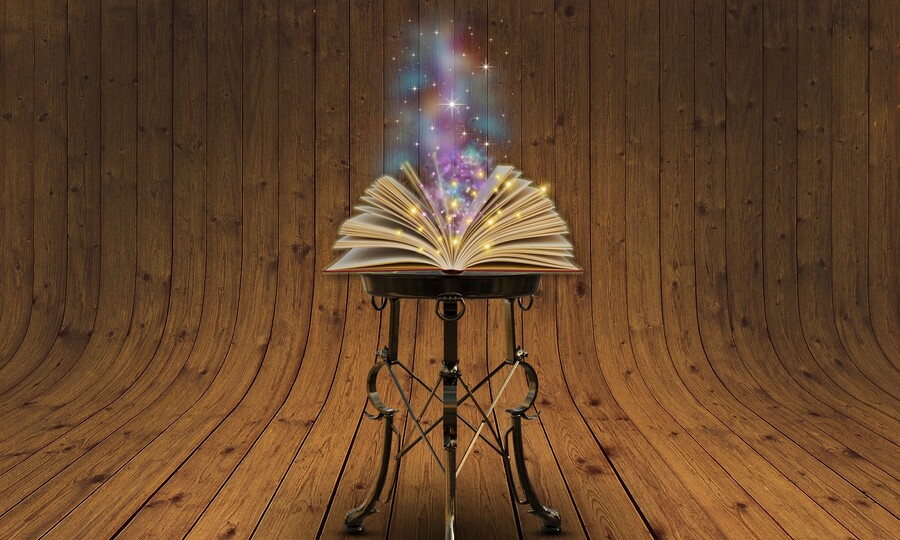 Buch auf schmalem Tisch es kommt glitzernder Rauch heraus