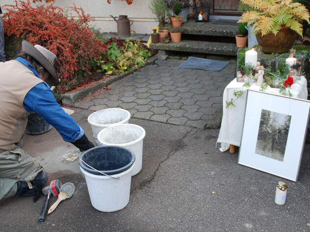 A Stolperstein is placed in the ground, with memorial